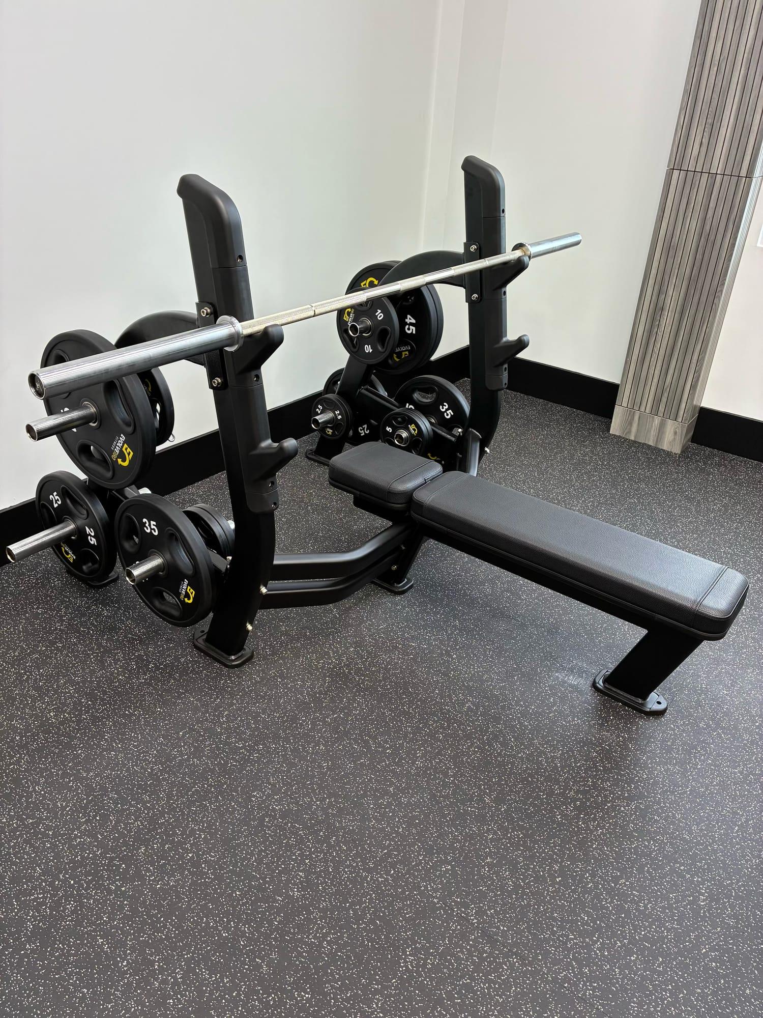 Flat bench press station loaded with plates