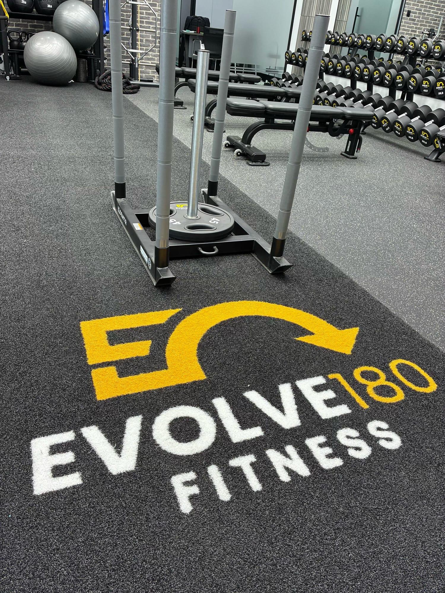 Evolve180 logo on the training turf with a push sled