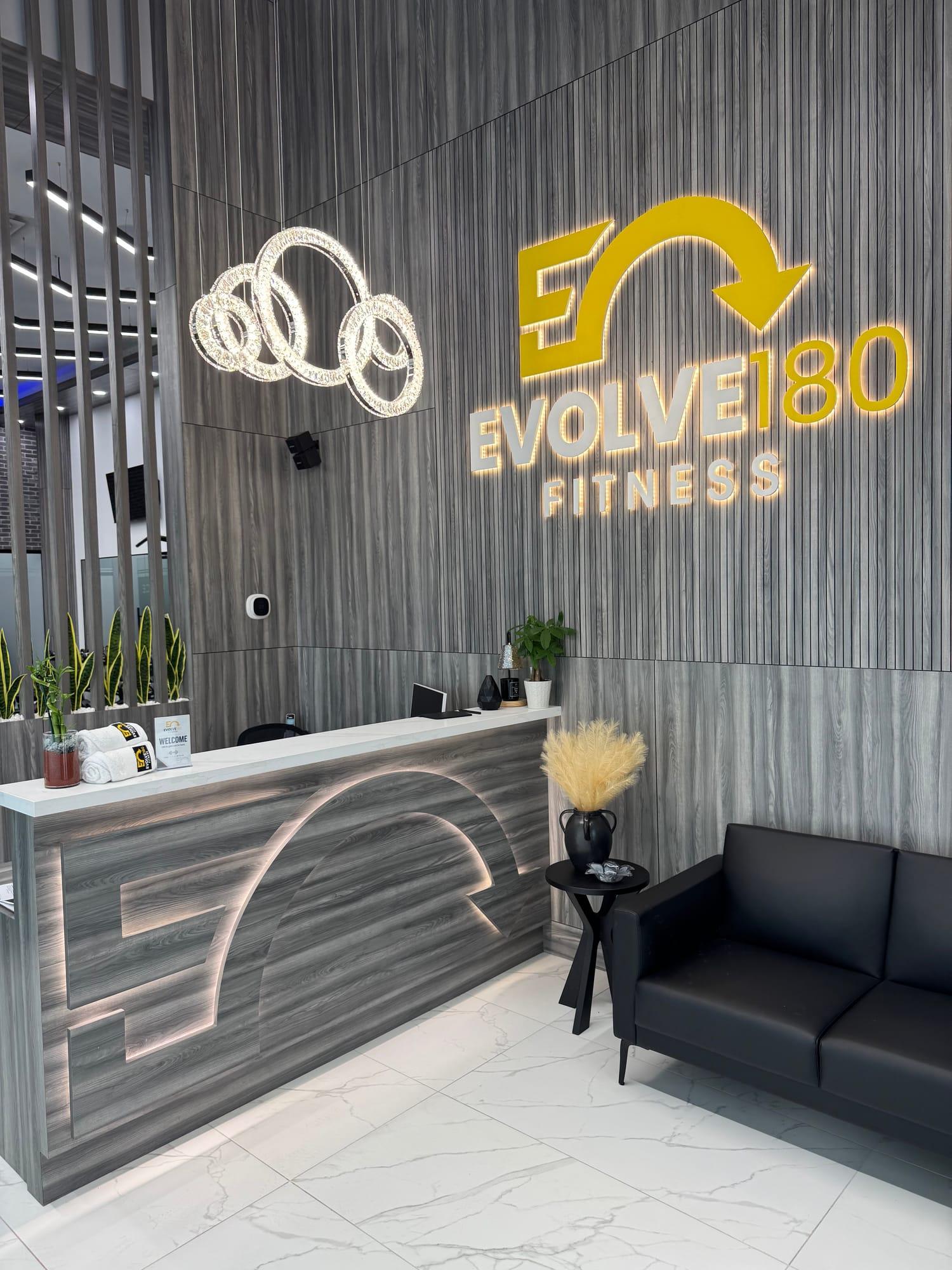 Evolve180 reception desk and illuminated logo wall
