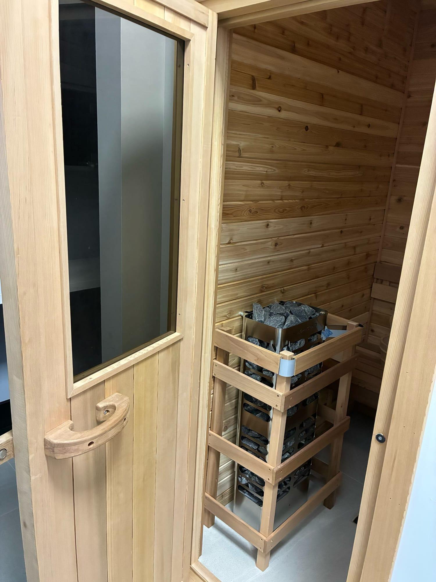 Sauna with a traditional stone heater