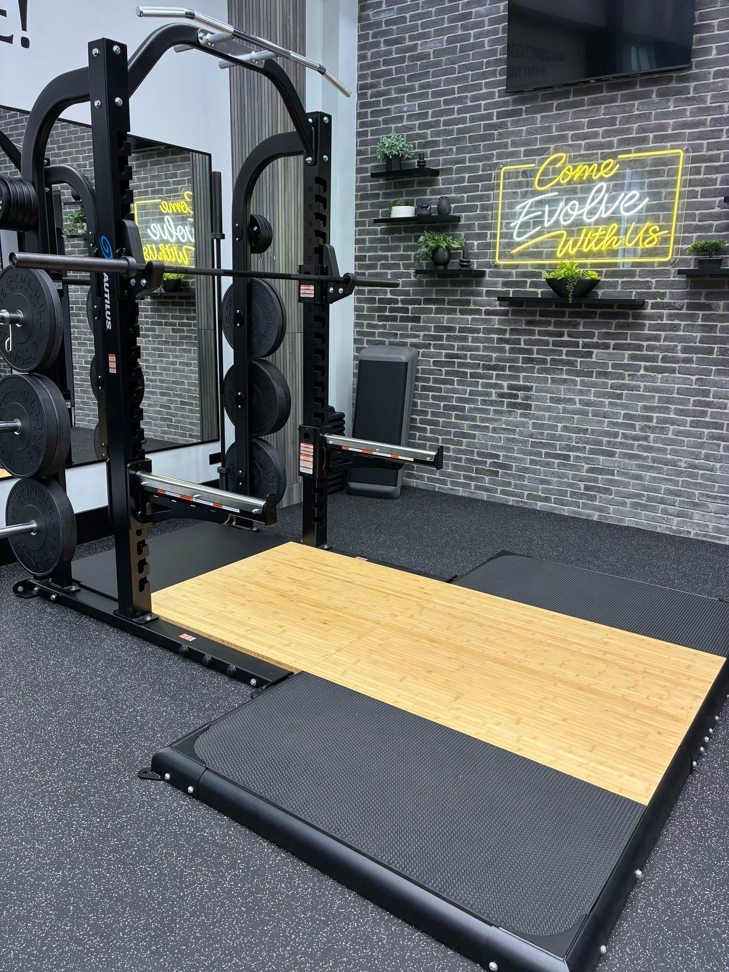 Squat rack with a wooden lifting platform